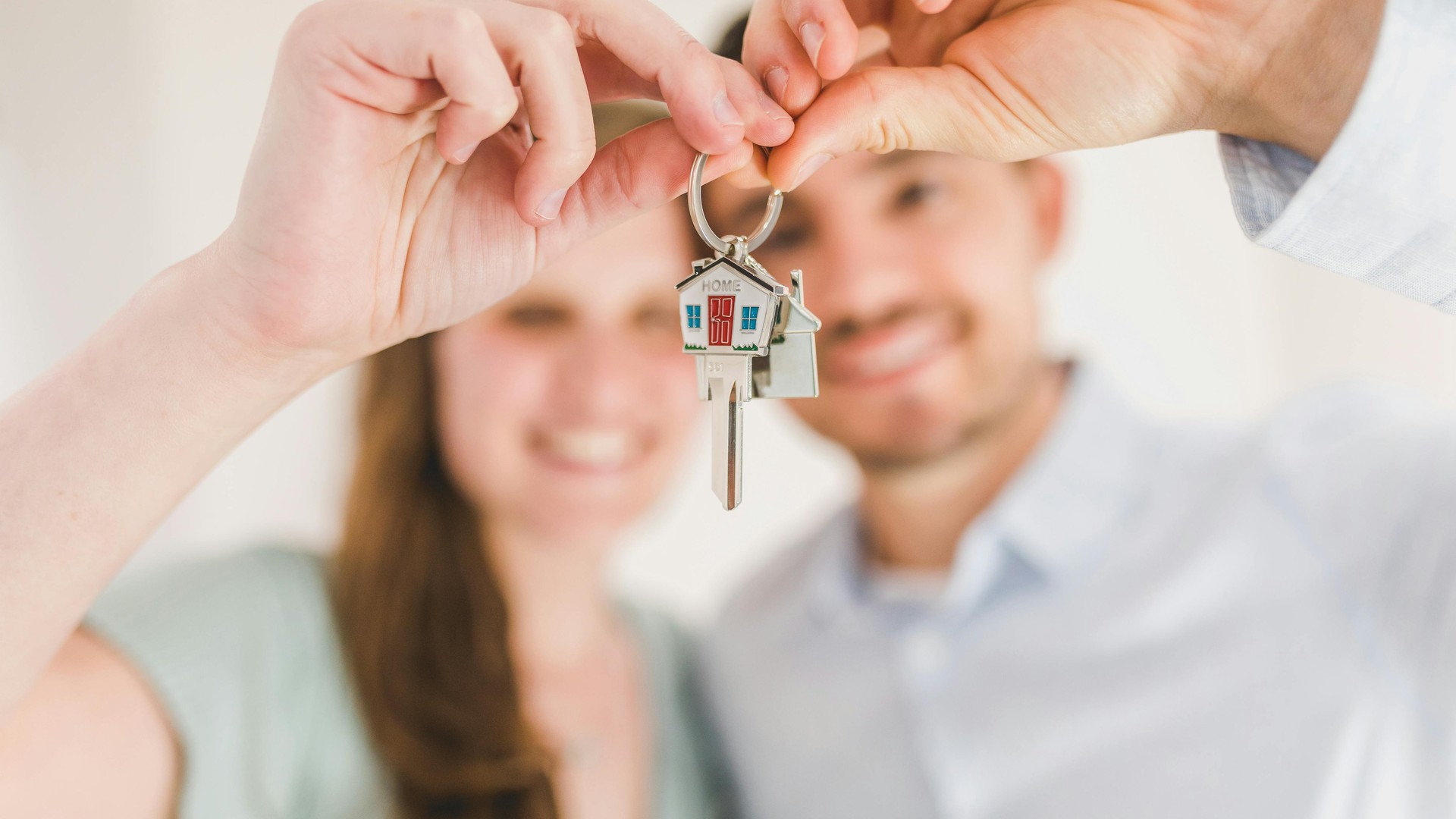 Couple celebrating with keys to their new home